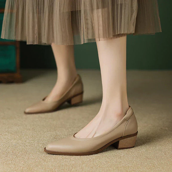 Versatile black mid-heel pumps for women, featuring a chic pointed toe and stable block heel.