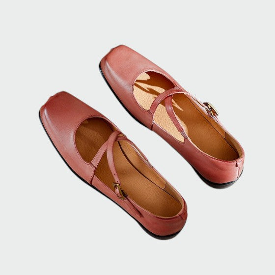 Close-up of black square-toe Mary Jane shoes, showing cross-strap detail and block heel
