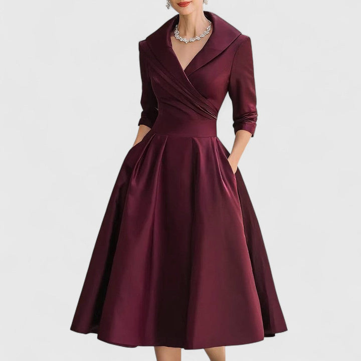 Stylish navy blue V-neck midi dress for women, featuring comfortable 3/4 sleeves and a flattering flared skirt.