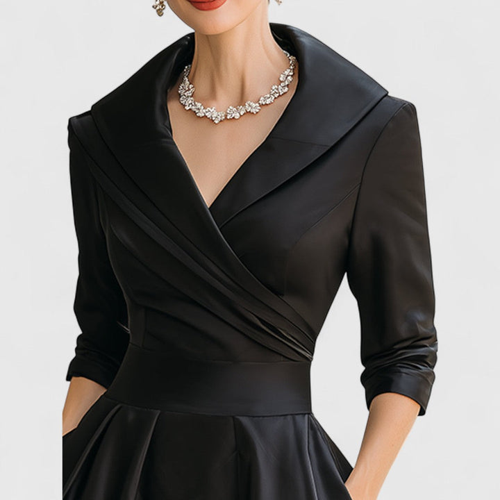 Women's versatile black midi dress, designed with a V-neck, 3/4 sleeves, and a casual yet elegant flared skirt.