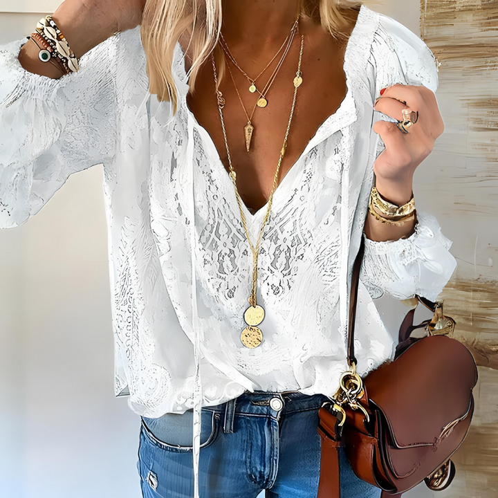 Feminine lightweight V-neck blouse with boho flair, ideal for summer fashion.
