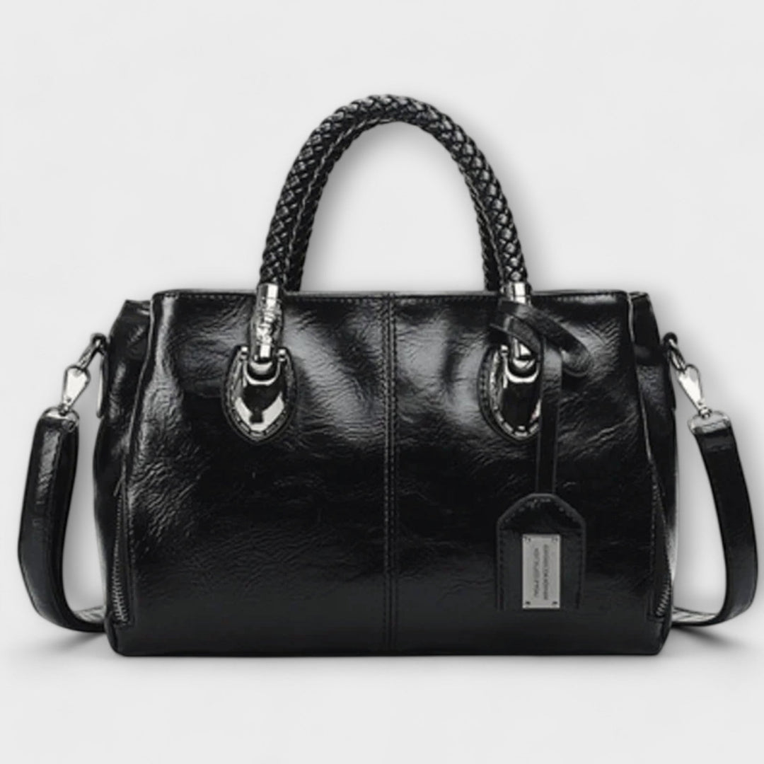 Close-up of the unique braided handle on a chic women's fashion handbag