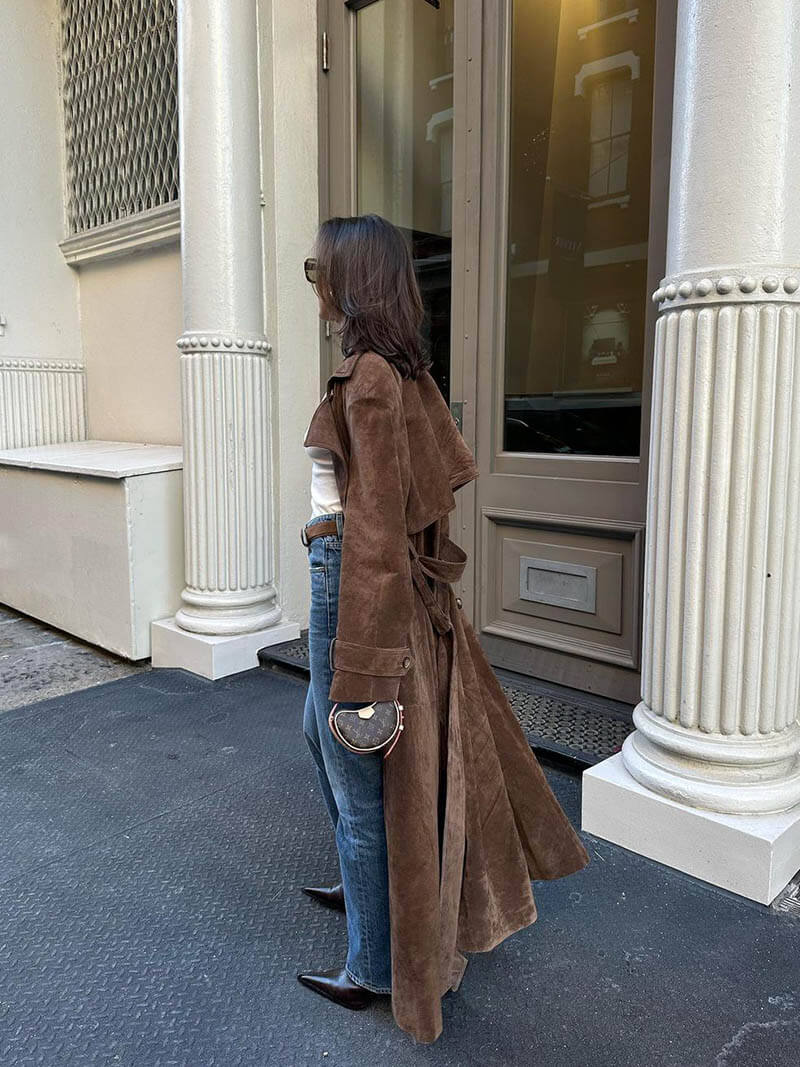 Brown elegant belted long trench coat for women, showing sophisticated lapel detail and fit