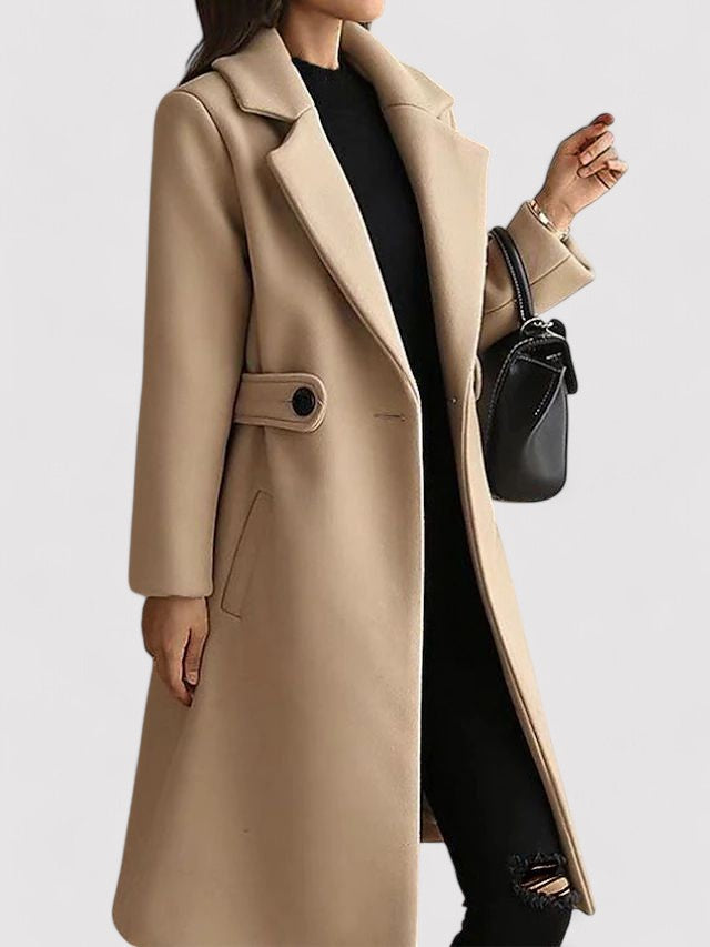 Close-up of a women's red wool blend long winter coat with a belted waist, showcasing luxurious texture