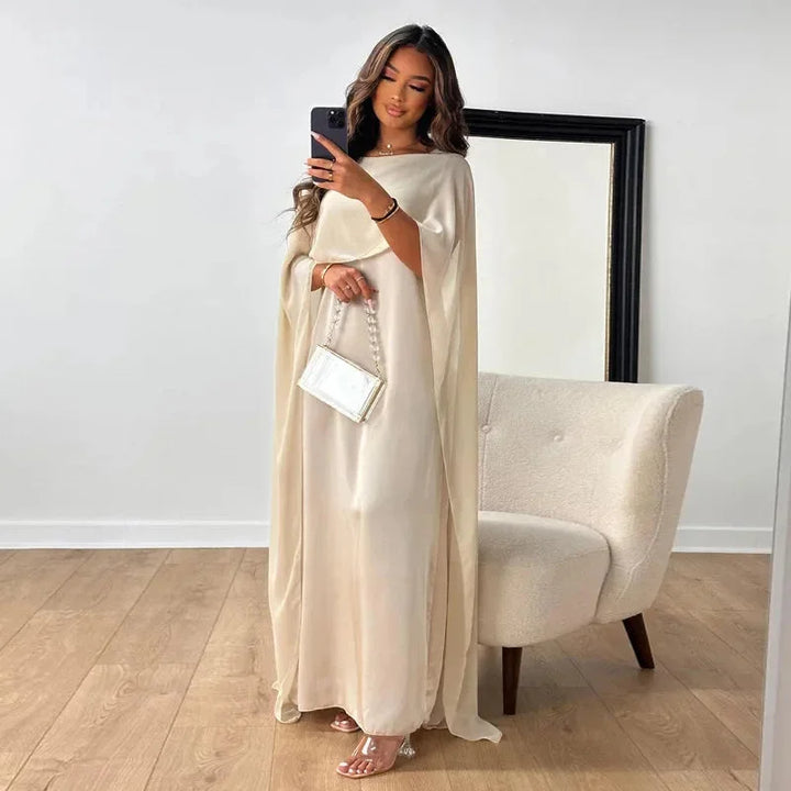 Elegant women's cape maxi dress in blush pink, perfect for wedding guests and formal evening wear.