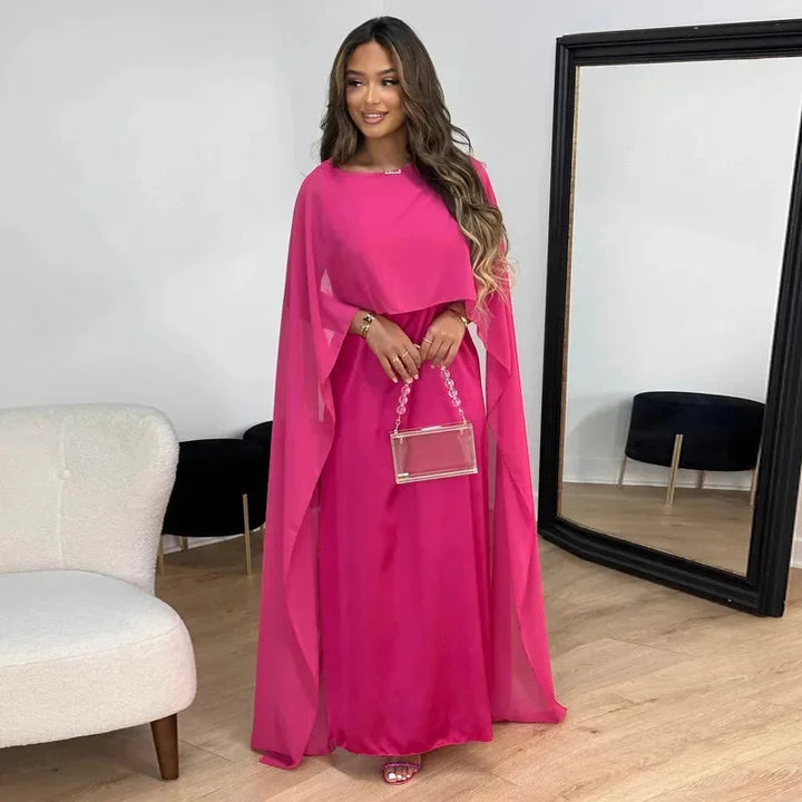 Sophisticated long black cape dress for women, ideal for special occasions and as a wedding guest outfit.