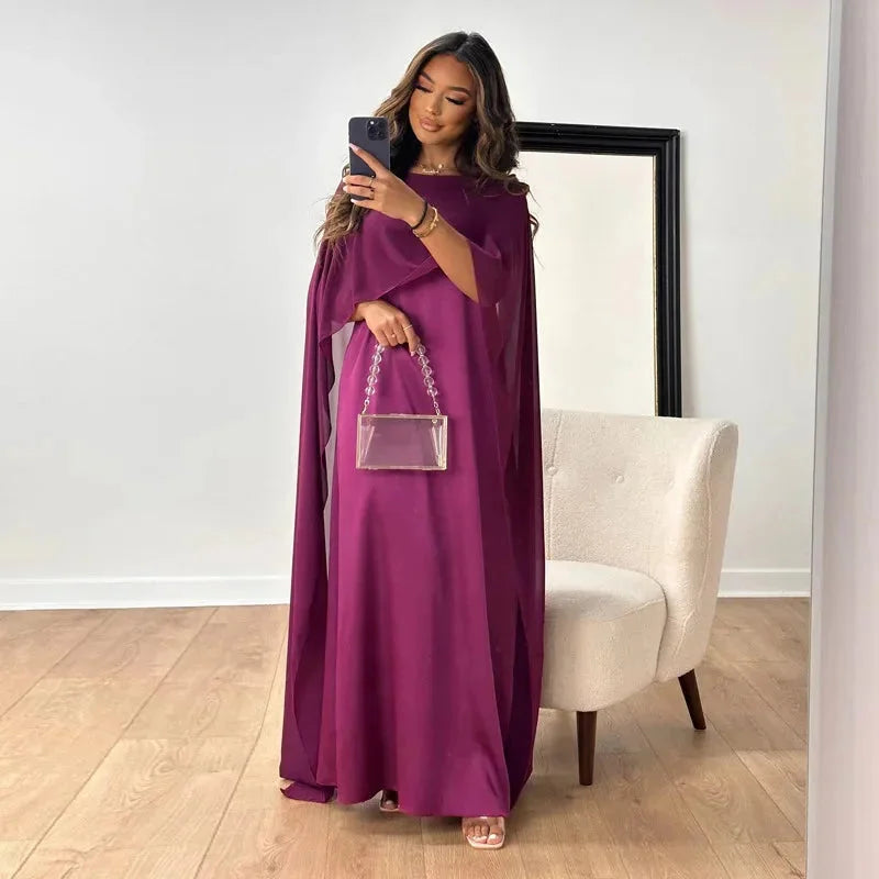 Graceful red cape maxi dress with flowing silhouette, a beautiful option for wedding guests and evening wear.