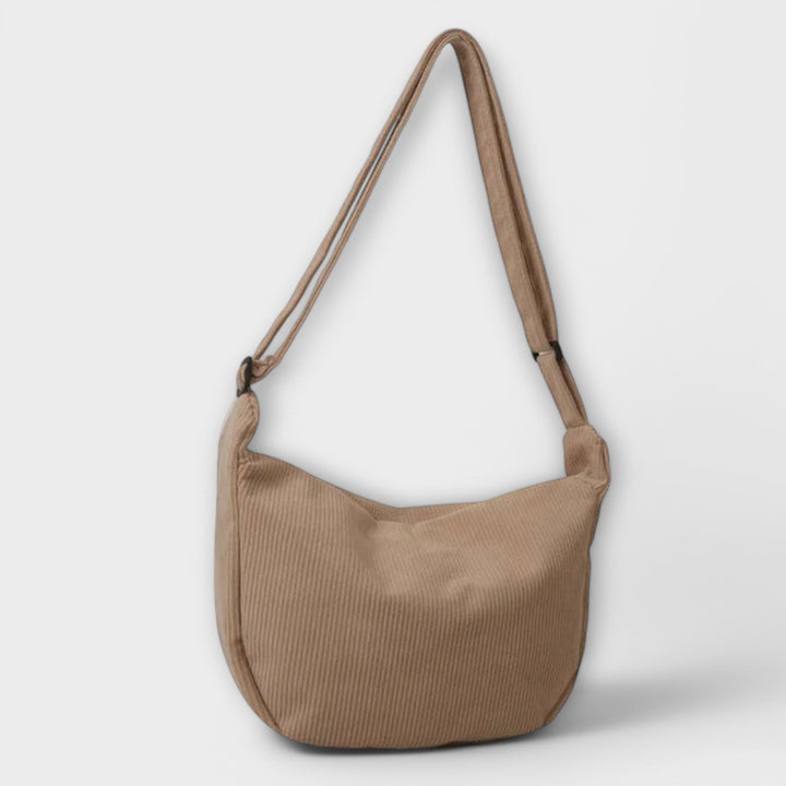 Women's chic curved shoulder bag in vibrant color, a trendy summer bag and fashion accessory.