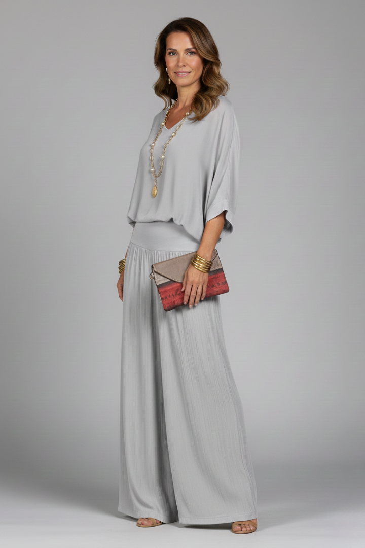 Women's resort wear, a V-neck chiffon top and wide-leg pant co-ord set in a vibrant color.