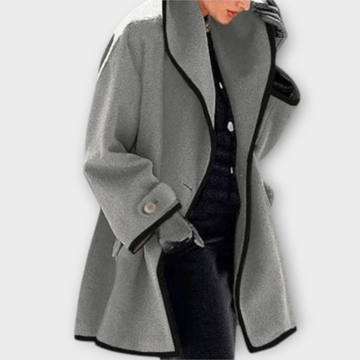 Close-up of a women's trench coat detailing the belt and classic wide lapels, elegant style.