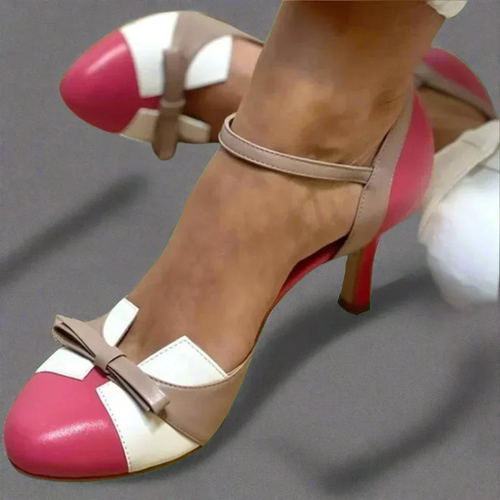 Close-up of women's mid heel pumps featuring a stylish bow strap, perfect for an elegant look