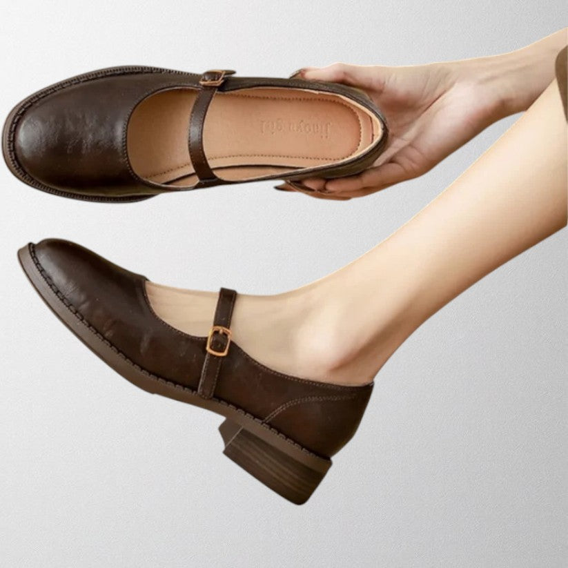 Close-up of a women's classic Mary Jane pump, highlighting the buckle and smooth leather finish
