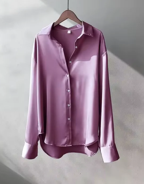 Close-up of the elegant button detail on a women's classic long sleeve workwear blouse