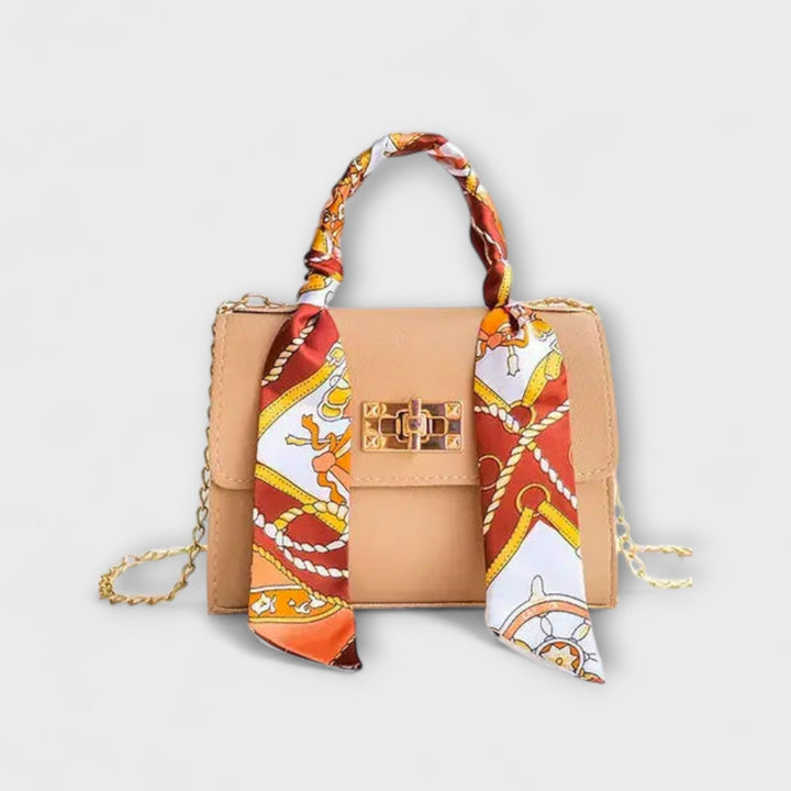 Women's handbag featuring a sophisticated chain strap, ideal for a stylish summer accessory