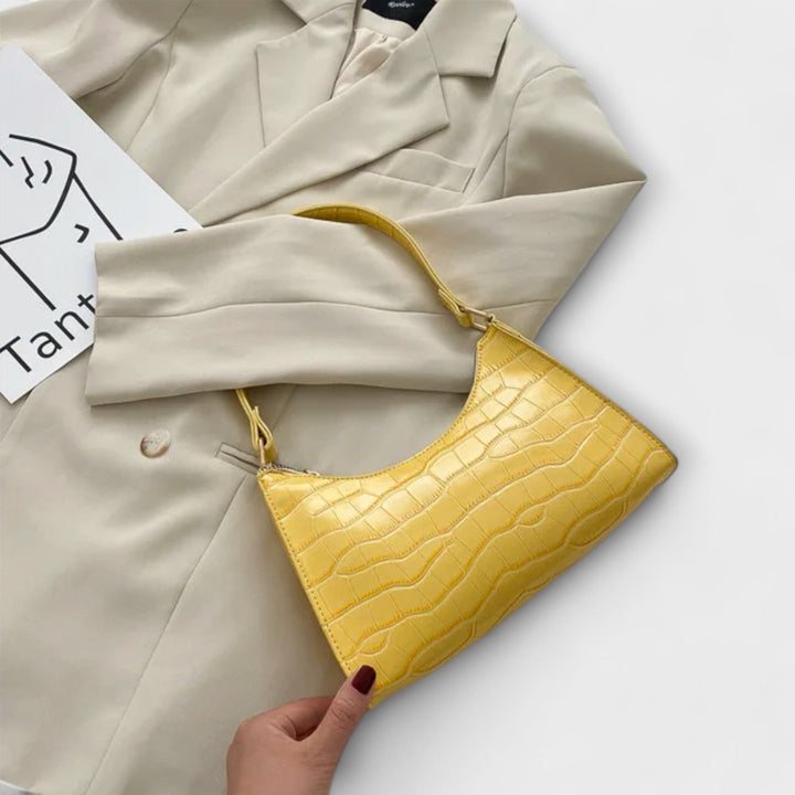 Everyday women's textured shoulder bag with an adjustable strap, perfect for comfort and style.