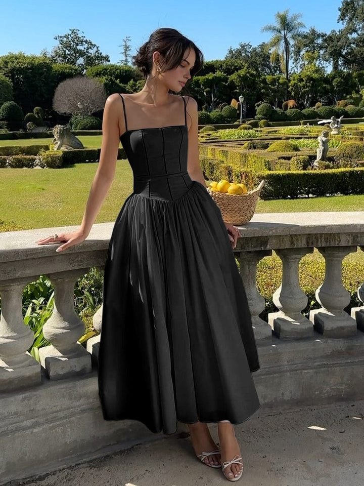 Chic women's party dress with a structured corset and flowing midi skirt, suitable for formal events.