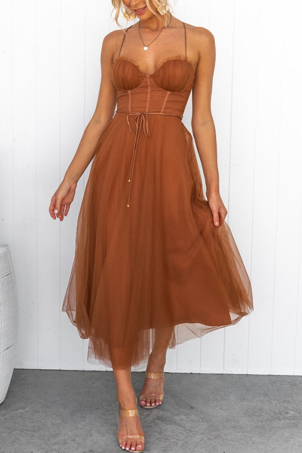 Flowing tulle skirt of a women's elegant midi dress, paired with a stylish corset top.