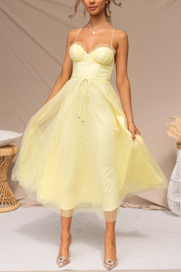 Close-up of the elegant tulle fabric on a women's special occasion midi corset dress.