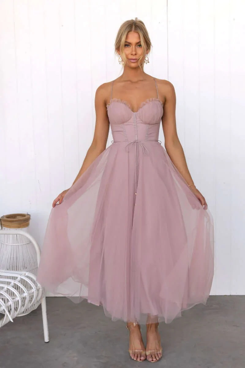 Stylish women's midi dress featuring a structured corset top and flowing tulle skirt.
