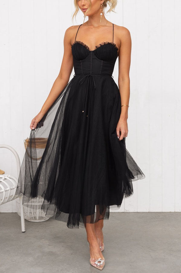 Chic women's party dress: Corset top, airy tulle midi skirt, and thin spaghetti straps.