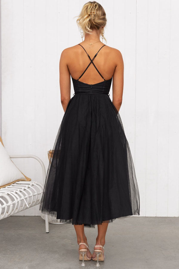 Women's fashion: Graceful corset midi dress with a voluminous tulle skirt and spaghetti straps.