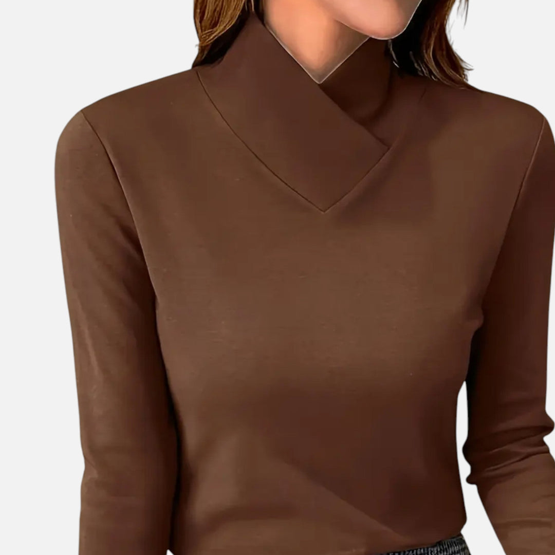 Fashionable women's criss-cross neck long sleeve top. An elegant and comfortable blouse for any occasion.