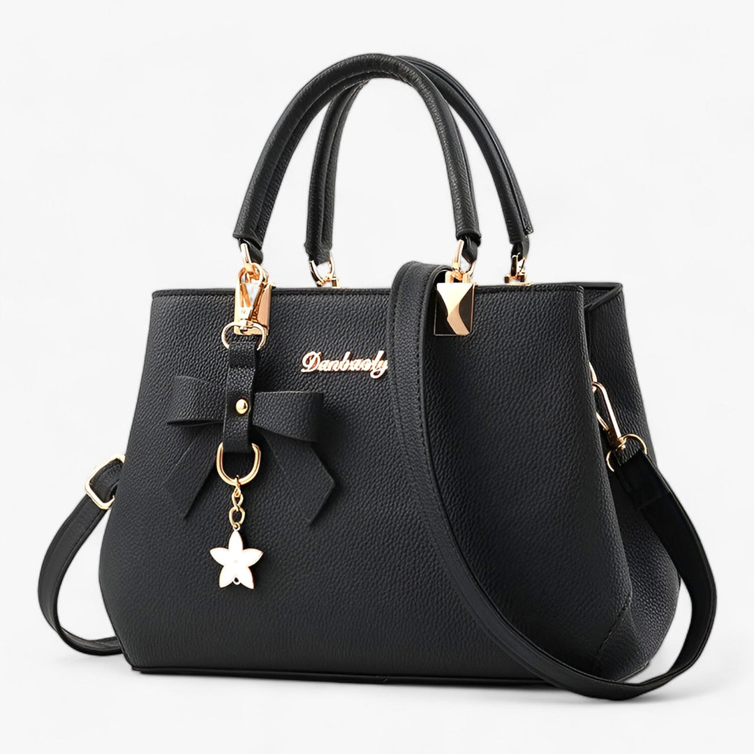 Stylish women's elegant crossbody bag featuring a charming floral pendant, ideal for daily & business fashion.