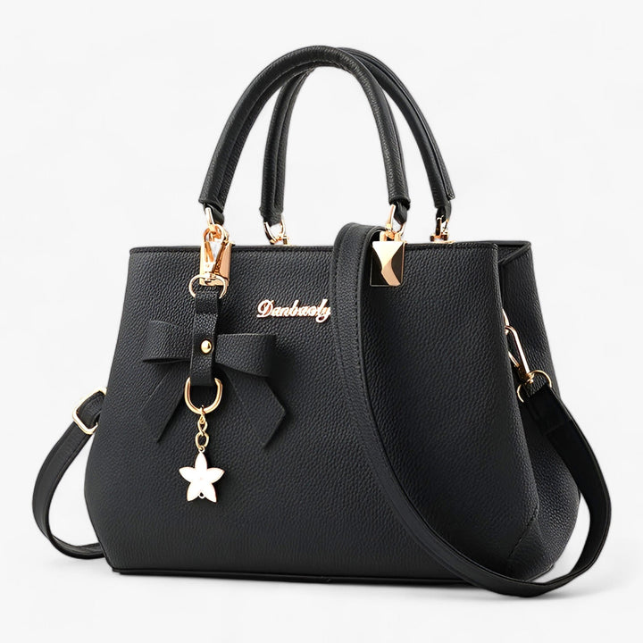 Stylish women's elegant crossbody bag featuring a charming floral pendant, ideal for daily & business fashion.