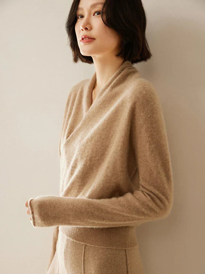 Dynamic shot of a model moving in a women's loose-fitting crossover wrap sweater.