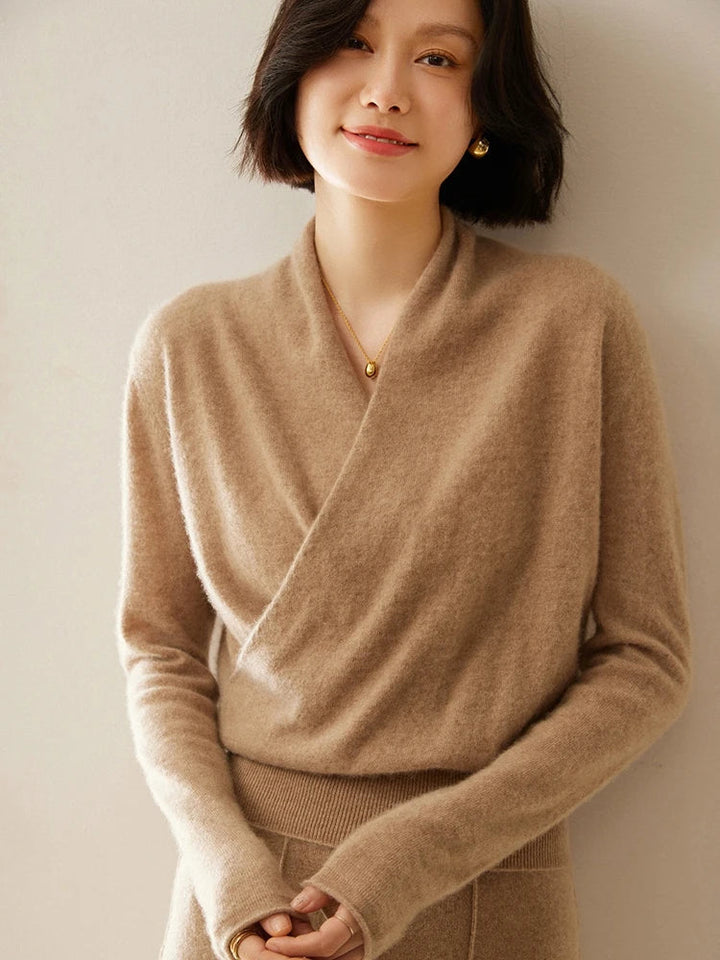 Studio shot of a women's plain white crossover wrap sweater against a neutral background.