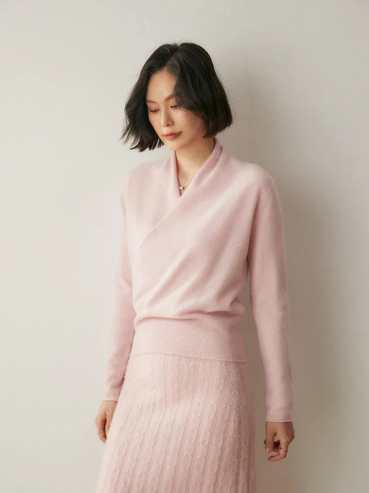 Detail of the adjustable tie-waist on a women's long sleeve wrap sweater.