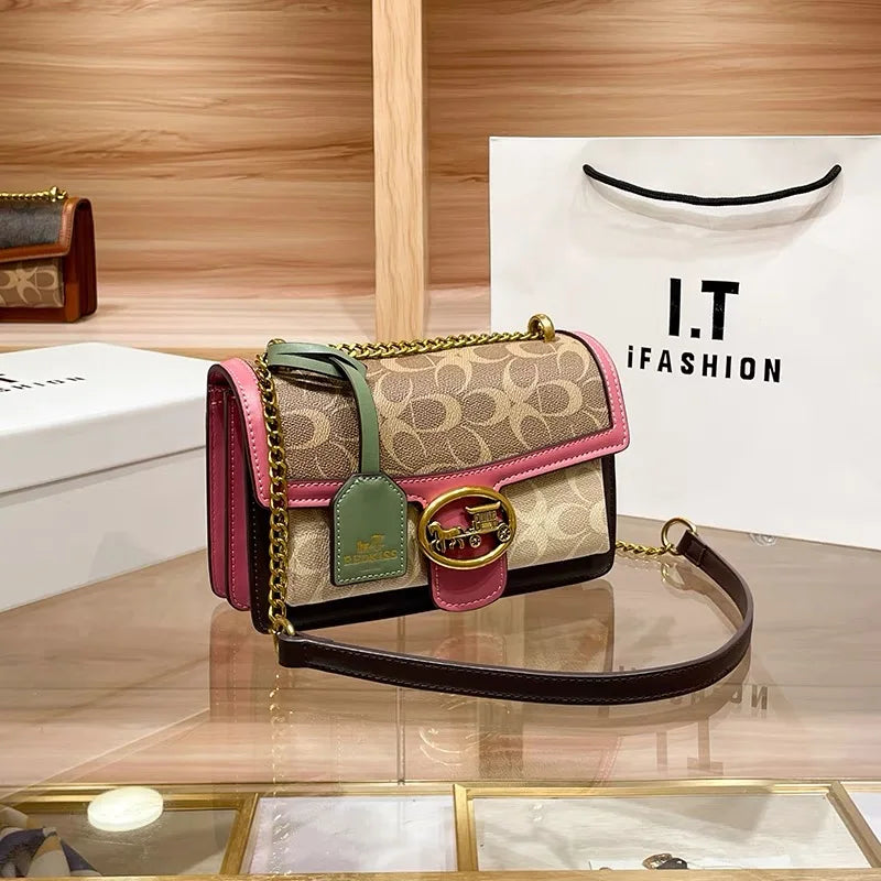 Chic women's mini designer crossbody bag featuring a unique colorblock strap and elegant gold chain detail.