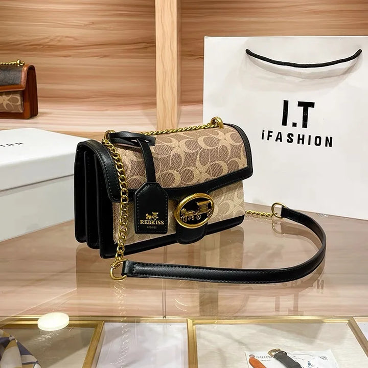 Modern women's designer crossbody bag with a distinctive colorblock strap, a chic and practical fashion accessory.