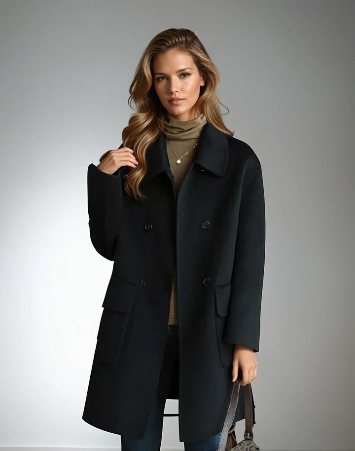 Detail of the luxurious cashmere feel fabric on a women's double-breasted fall coat.