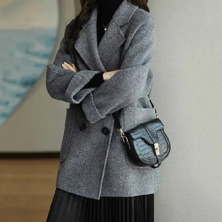 Side profile of a women's double-breasted winter coat with a soft cashmere feel texture.