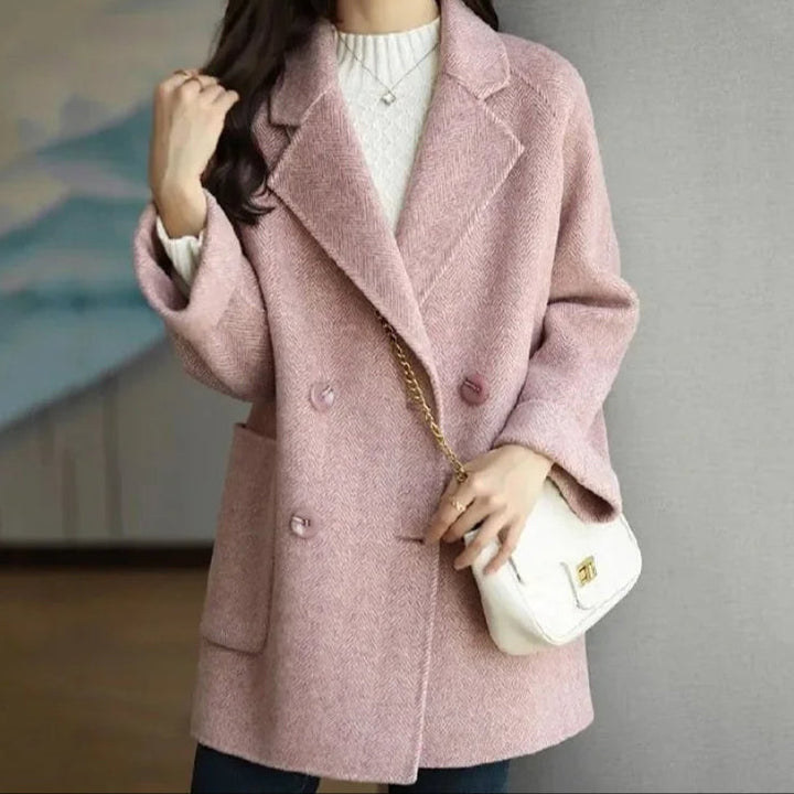 Close-up of buttons and lapels on a women's double-breasted cashmere feel coat, classic style.