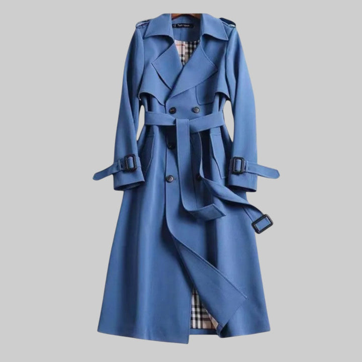Stylish women's belted long trench coat, double-breasted with classic lapels, an elegant outerwear for fall fashion.