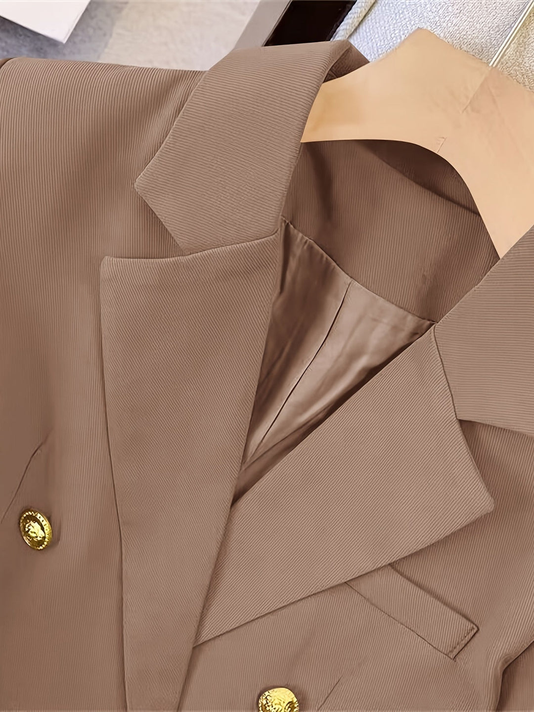 Women's double-breasted tailored blazer, an essential long sleeve outerwear piece for a polished winter look