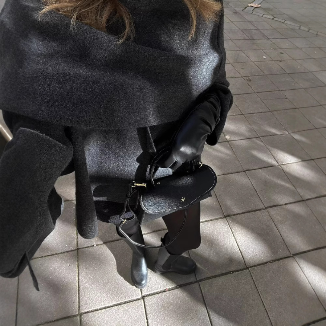 Front view of the elegant draped cape coat, highlighting its sophisticated cut for women's winter apparel.