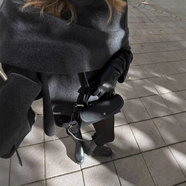 Front view of the elegant draped cape coat, highlighting its sophisticated cut for women's winter apparel.