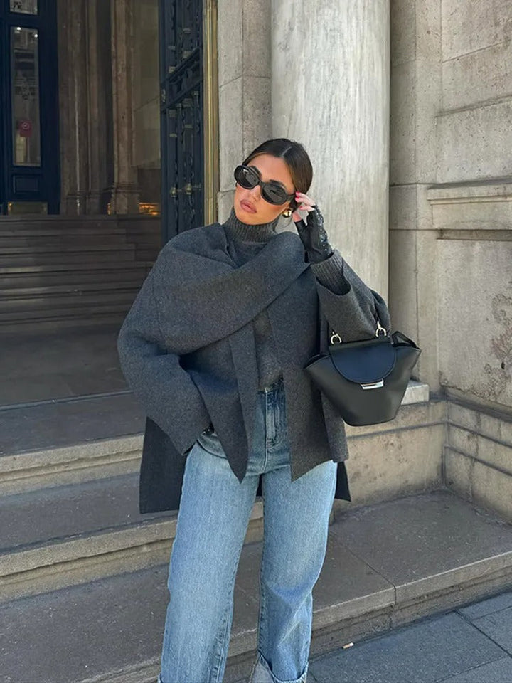 Women's elegant draped cape coat, displayed on a mannequin to showcase its modern and chic design.