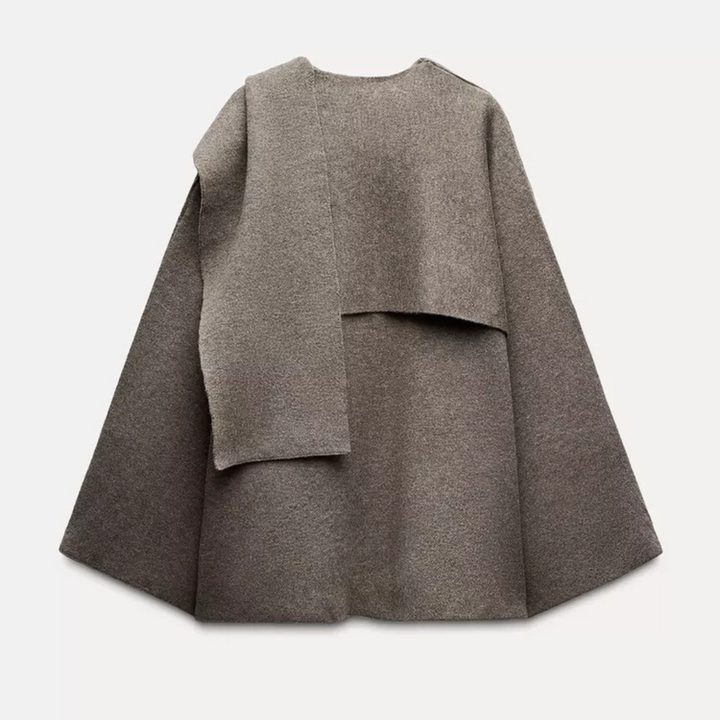 Fashionable women's draped cape coat in a neutral color, a versatile and elegant outerwear choice for winter.