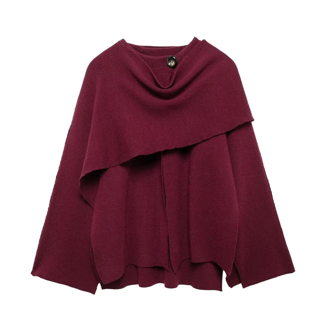 Full-length view of a woman wearing an elegant draped cape coat, highlighting its sophisticated silhouette.