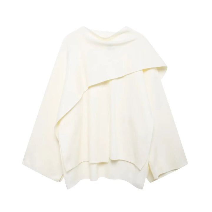 Close-up of the draped detailing on an elegant women's cape coat, emphasizing its unique style.