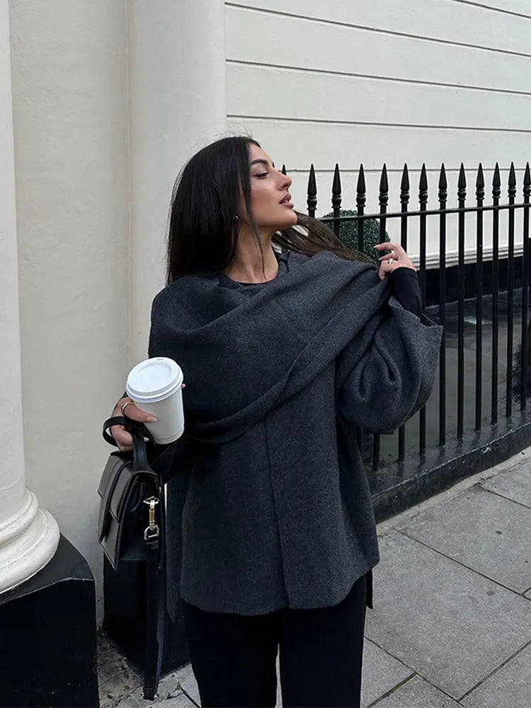 Back view of the elegant women's draped cape coat, revealing its flowing design and fashion appeal.