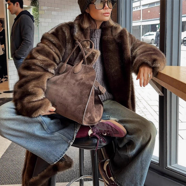 Warm women's faux fur coat, perfect for winter fashion. Luxurious, elegant, and a comfortable plush jacket.