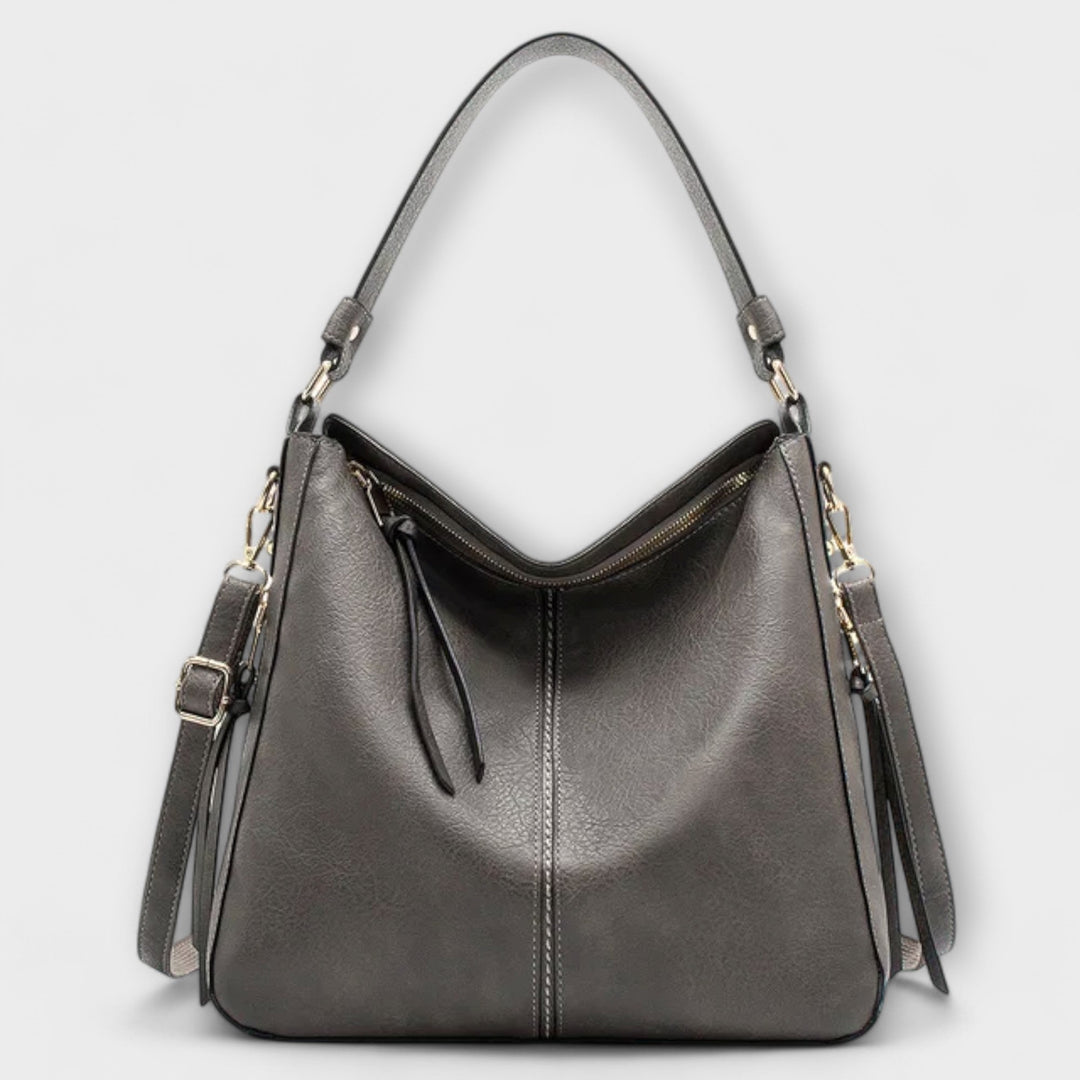 Elegant women's faux leather handbag, showcasing its refined texture and practical design