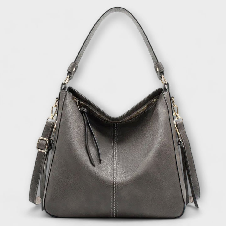 Elegant women's faux leather handbag, showcasing its refined texture and practical design