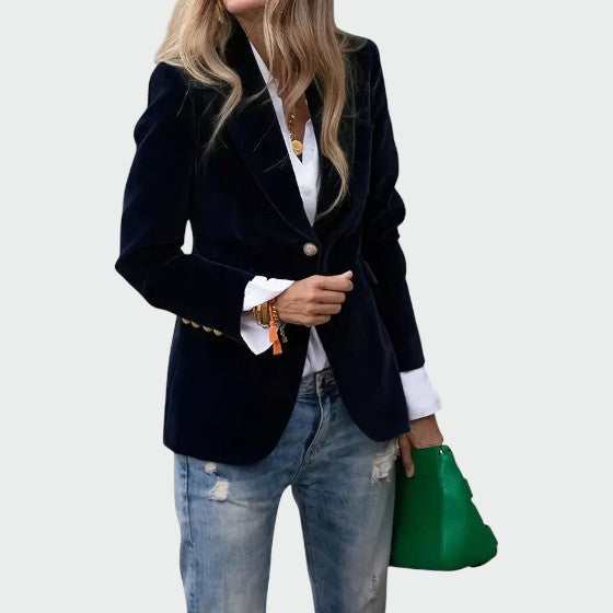 Close-up of a luxurious women's fitted velvet blazer jacket, highlighting the soft fabric and elegant design.