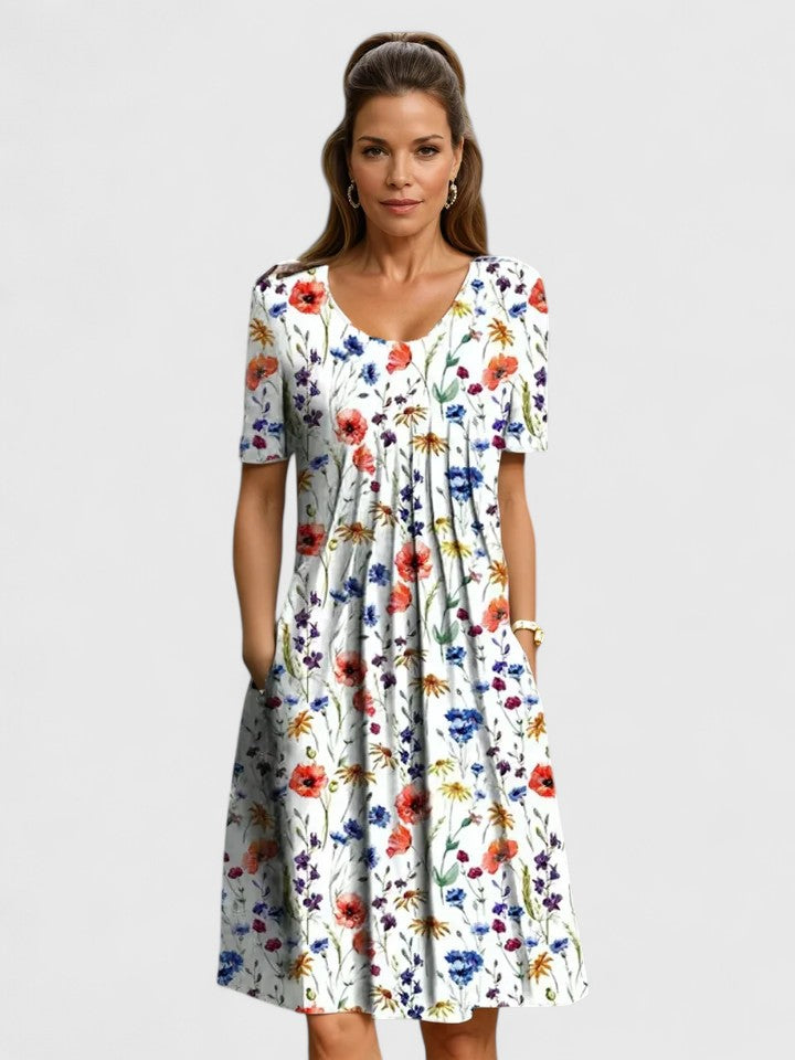 Vibrant floral print A-line dress for women, featuring a midi length, short sleeves, and practical pockets.
